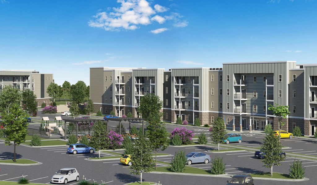 an aerial view of an apartment complex with cars in a parking lot