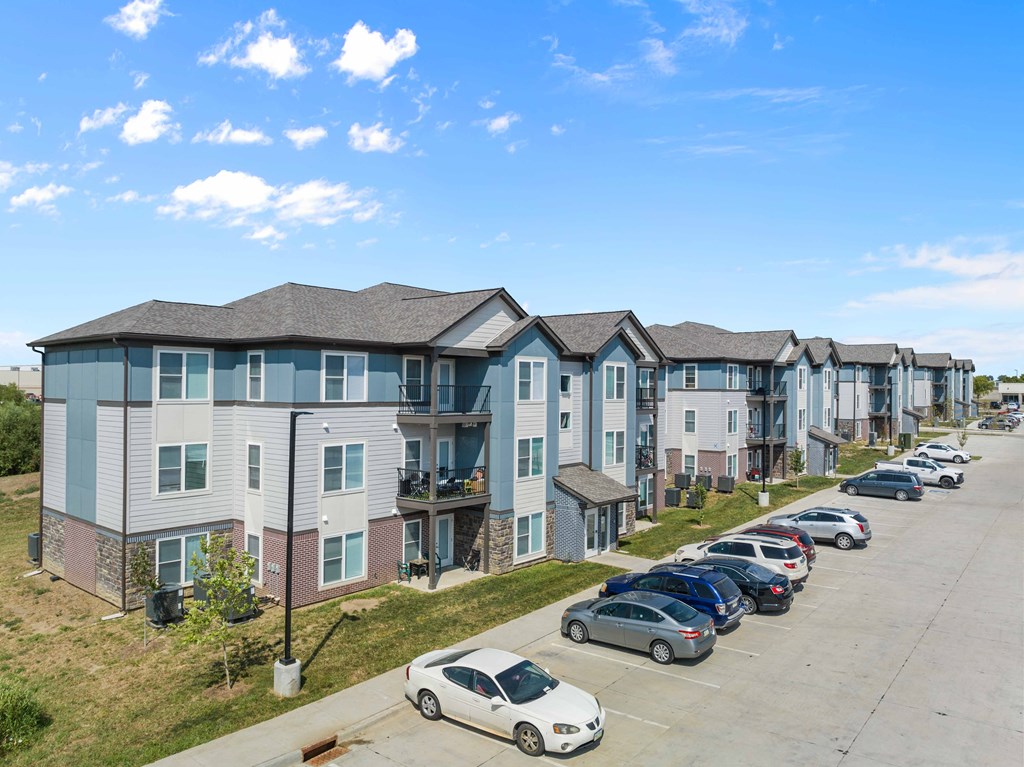 a row of townhomes with cars parked in front of them  at Union at Wiley, Iowa, 52404