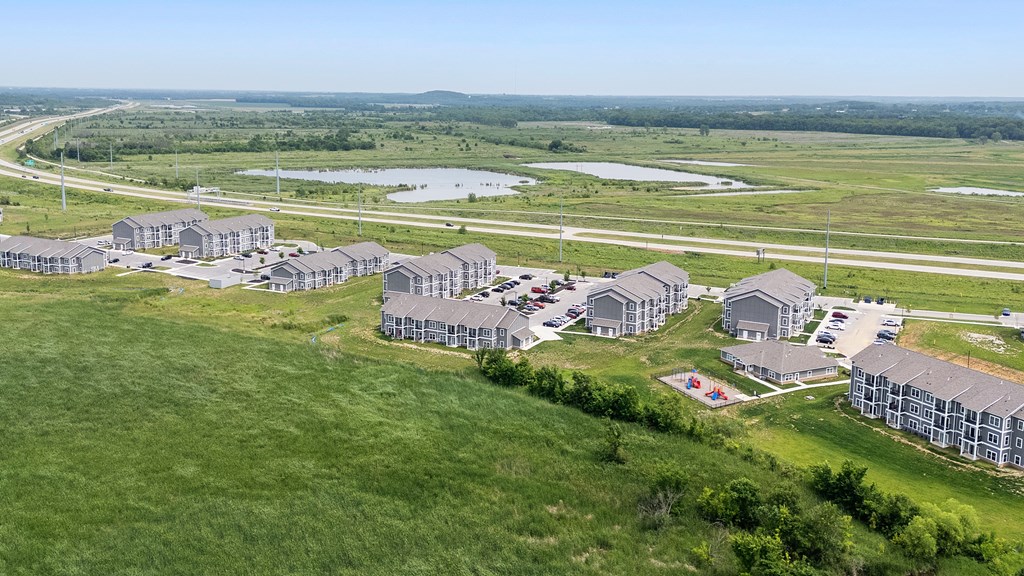 A bird's eye view of a residential area with houses and a playground. at Union at the Loop, Lawrence, Kansas