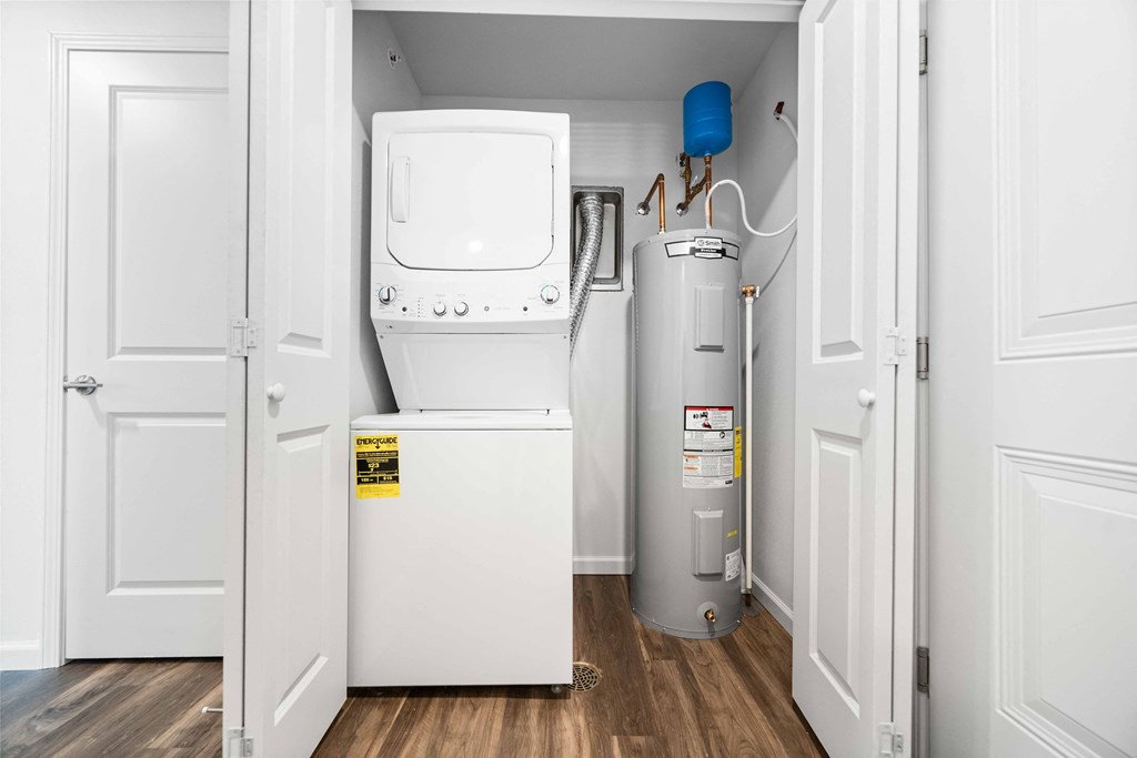 a small laundry room with a washer and dryer  at Union at Wiley, Cedar Rapids, 52404