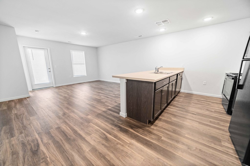 a kitchen and living room with hardwood floors and white walls  at Union at Wiley, Cedar Rapids, IA, 52404