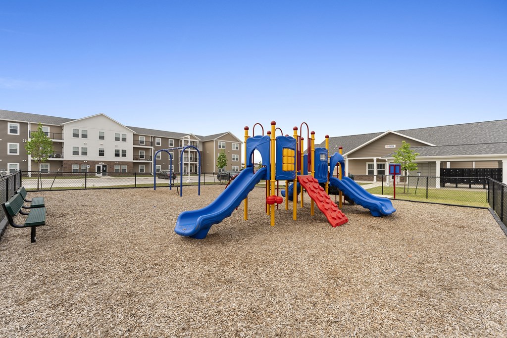 A playground with a blue slide and red slide.at Union at North Crossing, Iowa