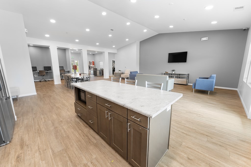 A modern kitchen with a large island and wooden floors.at Union at North Crossing, Iowa, 50703