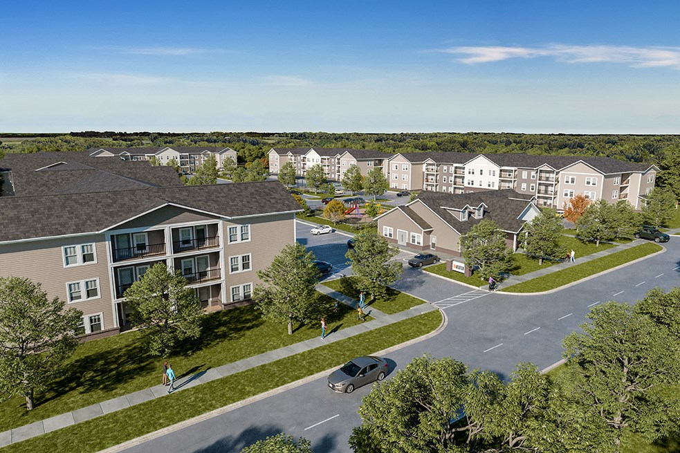 an aerial view of an apartment complex with a parking lot and trees at Union at North Crossing, Iowa
