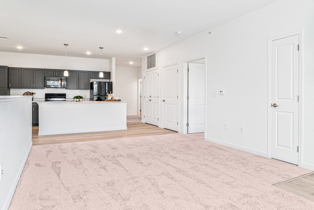 A kitchen with a white counter and a pink carpet. at Union at Oak Grove, Michigan, 48855