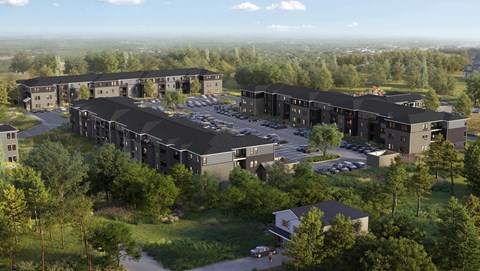 A large building complex with a parking lot in front.