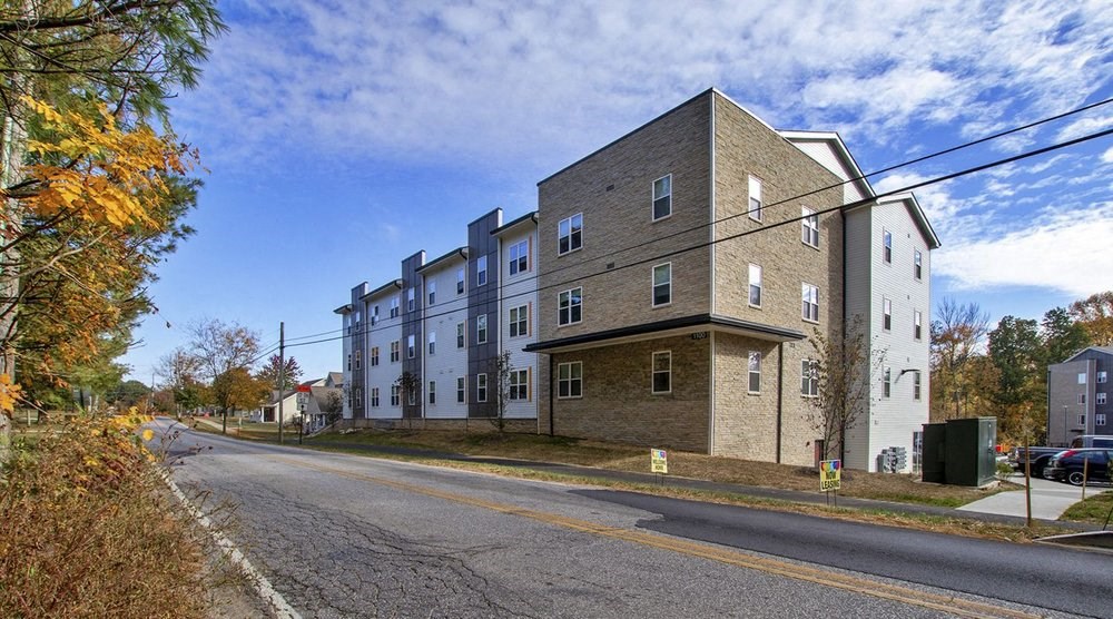 A street view of a residential area with apartment buildings.at Union at Crescent, Bloomington, IN  