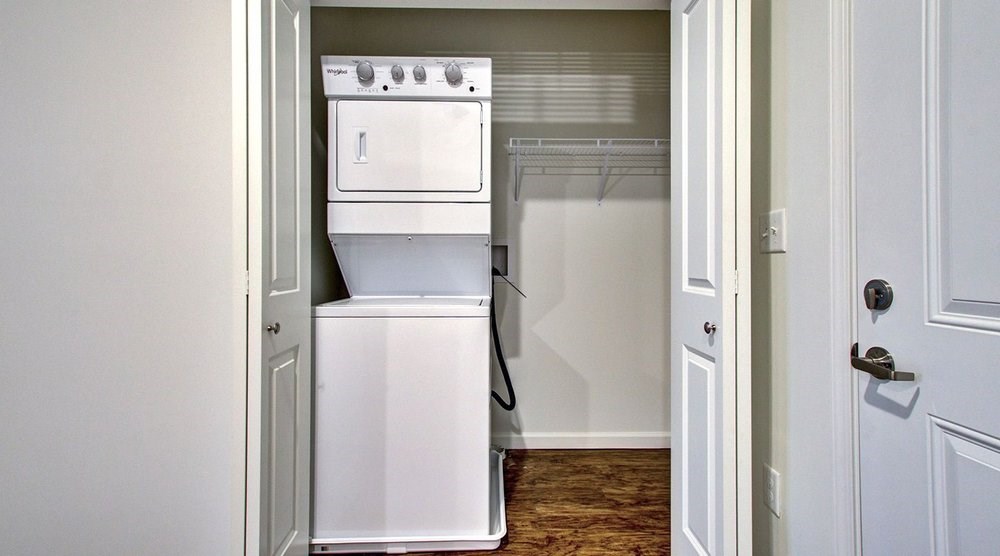 A white oven and dishwasher are in a small kitchen.at Union at Crescent, Indiana  