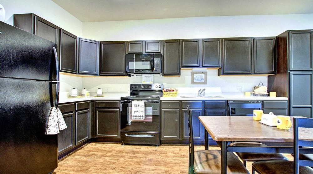 A kitchen with black appliances and cabinets.at Union at Crescent, Bloomington, IN 47404  