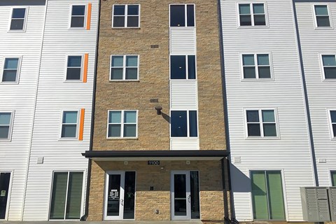 A building with a brown brick facade and white siding.at Union at Crescent, Bloomington, IN 47404