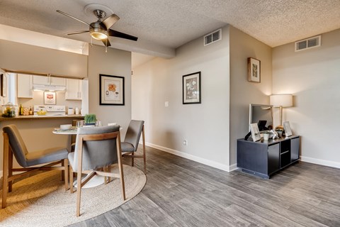 A living room with a grey chair and a wooden table.