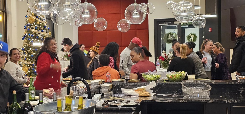 a christmas party in a kitchen with a bar and christmas tree at Metro 303, New York, 11550