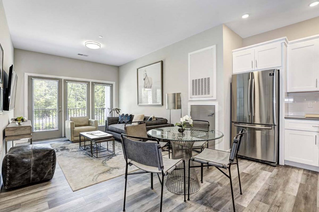 a kitchen and living room with a table and chairs