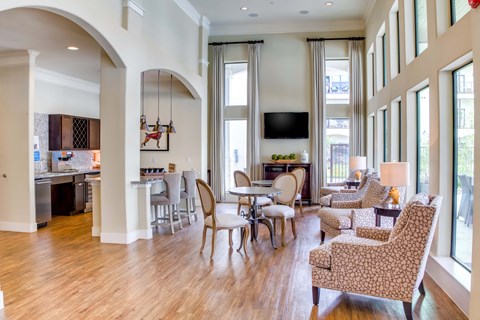 A living room with a large couch and chairs.