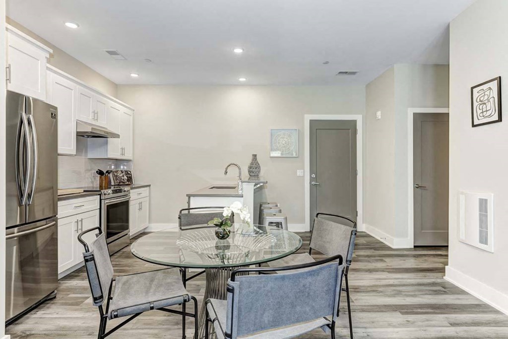 a kitchen and dining room with a table and chairs