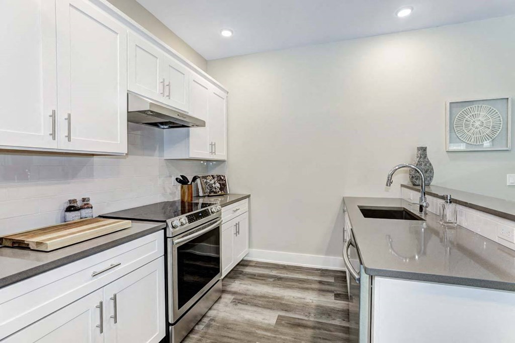 a kitchen with white cabinets and a sink