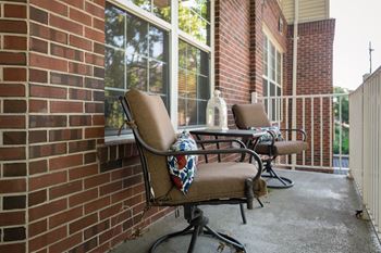 Two chairs are placed on a patio.