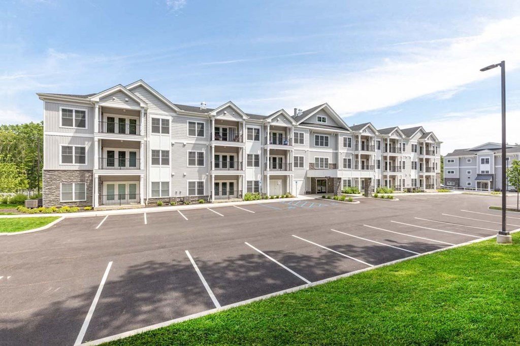 an empty parking lot in front of an apartment building