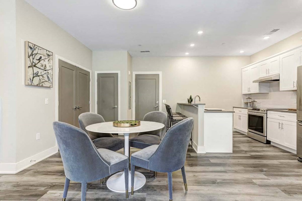a kitchen and dining room with a table and chairs