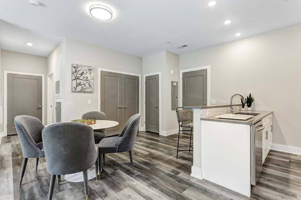 a dining room with a table and chairs next to a kitchen