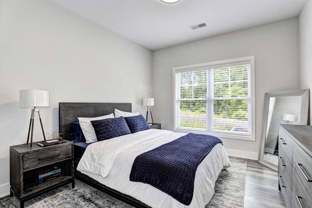 a bedroom with a bed and a window