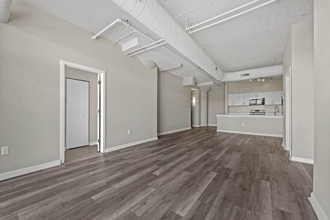 A room with a white ceiling and wooden flooring.