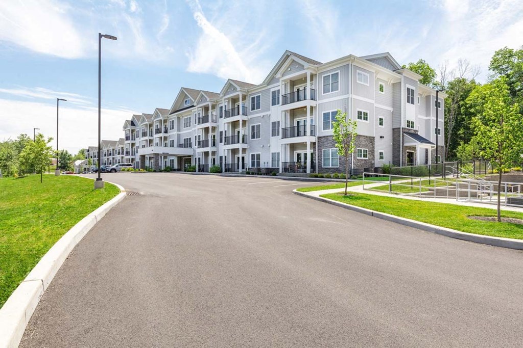 an empty street in front of an apartment building