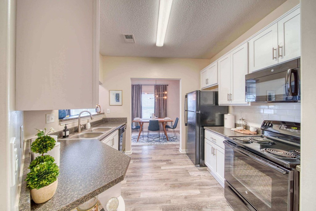 a kitchen with white cabinets at Meridian Obici, Virginia, 23434
