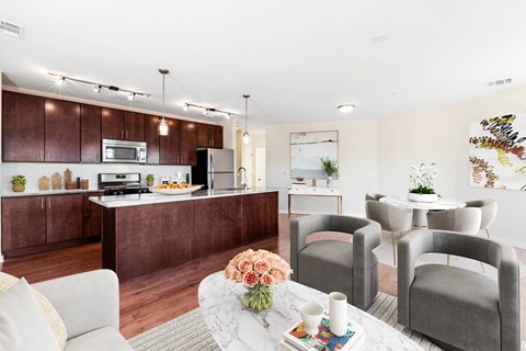 A modern kitchen with brown cabinets and a white island.