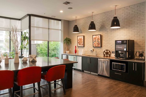 A modern kitchen with a dining table and chairs at Regatta Sloans Lake Apartments, Denver