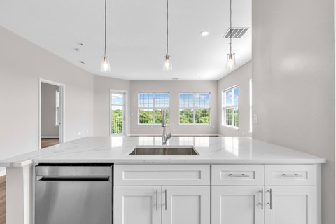 A modern kitchen with white cabinets and a large island.