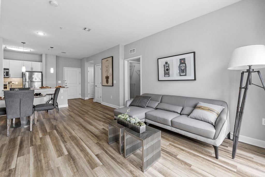a living room with hardwood flooring and grey couch  at Harbor Pointe, Bayonne, 07002