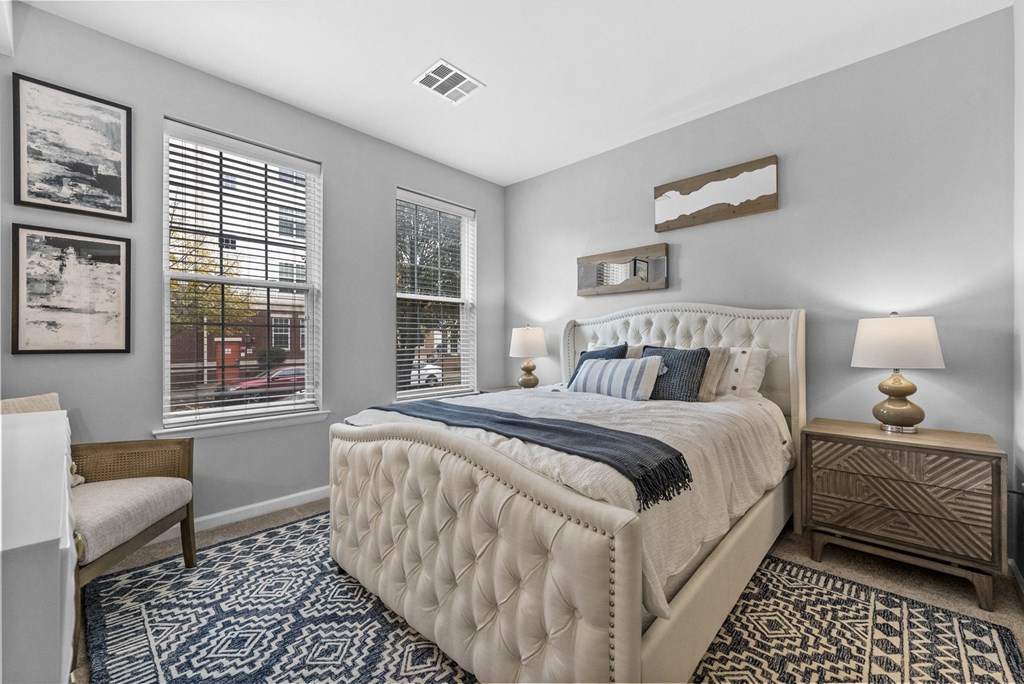 a bedroom with a large bed and two windows  at Harbor Pointe, Bayonne, NJ, 07002