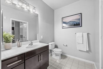 a bathroom with a toilet sink and mirror  at Harbor Pointe, Bayonne, New Jersey