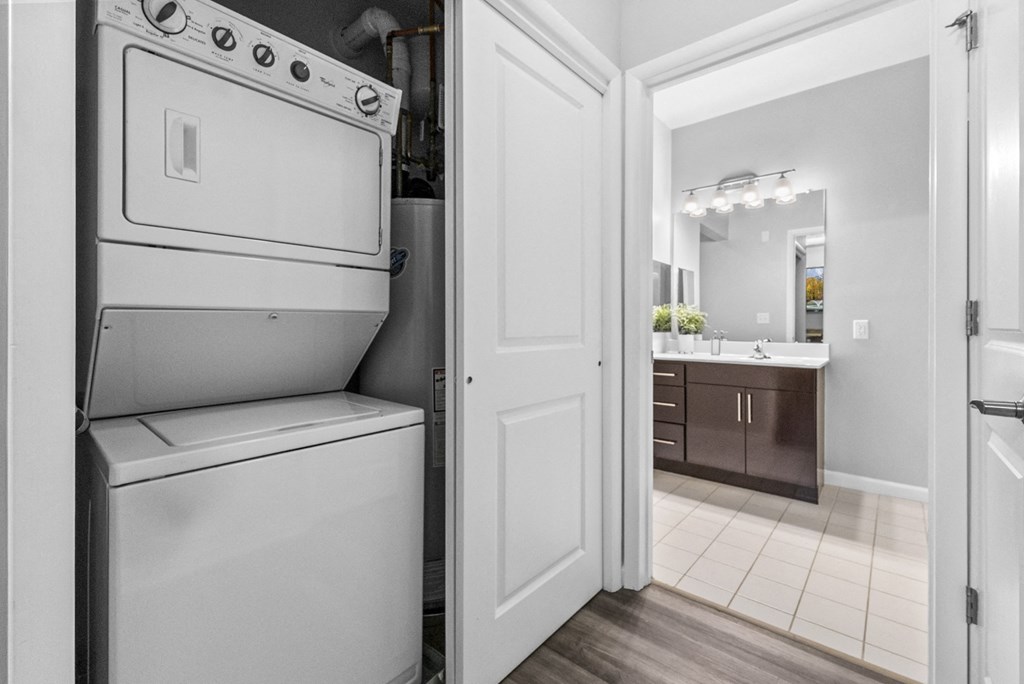 a washer and dryer in a kitchen with a bathroom in the background  at Harbor Pointe, Bayonne, New Jersey