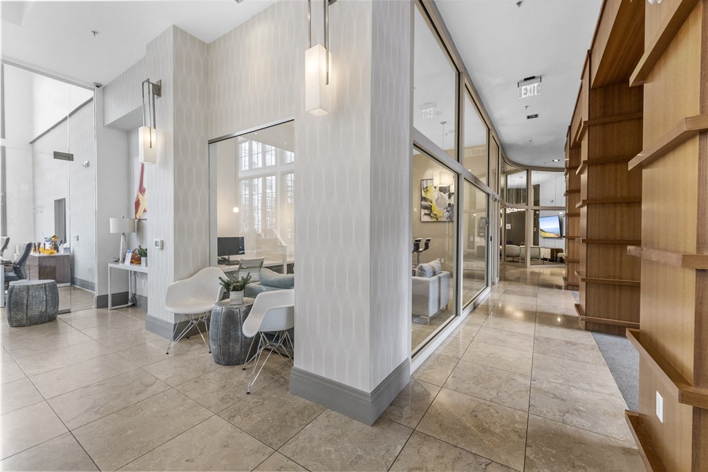 Hallway to Gym, Business Center, Game Room, and The Clubhouse with a pool table, entrance to outdoor pool, a bar and kitchen at Harbor Pointe, New Jersey, 07002