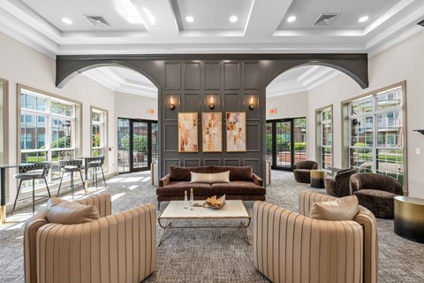 A modern living room with a large painting and a coffee table.