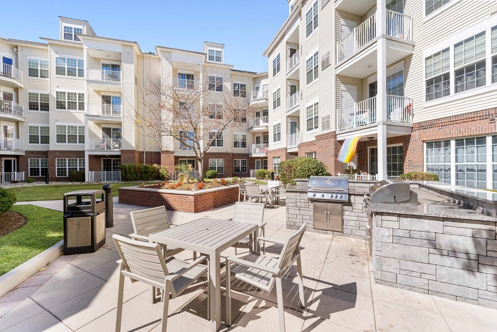 Courtyard with a grill and tables and chairs at The Lena, Raritan, 08869
