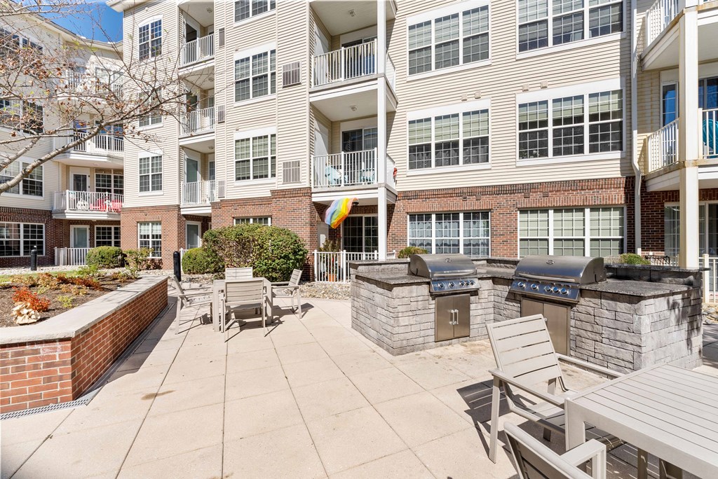 Courtyard with a grill and tables and chairs at The Lena, Raritan, 08869