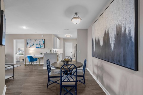 Open concept dining and kitchen with abstract artwork at The Lena Apartments, New Jersey