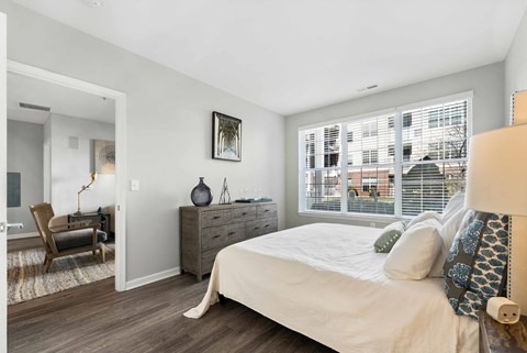 Bedroom with dresser and decorative pillows at The Lena Apartments, Raritan