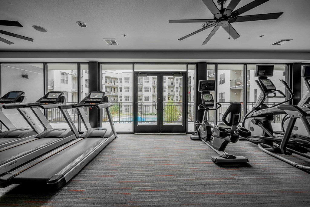 A gym with treadmills and elliptical machines at Regatta Sloans Lake Apartments, Denver, CO