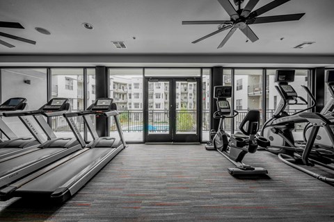 A gym with treadmills and elliptical machines at Regatta Sloans Lake Apartments, Denver, CO