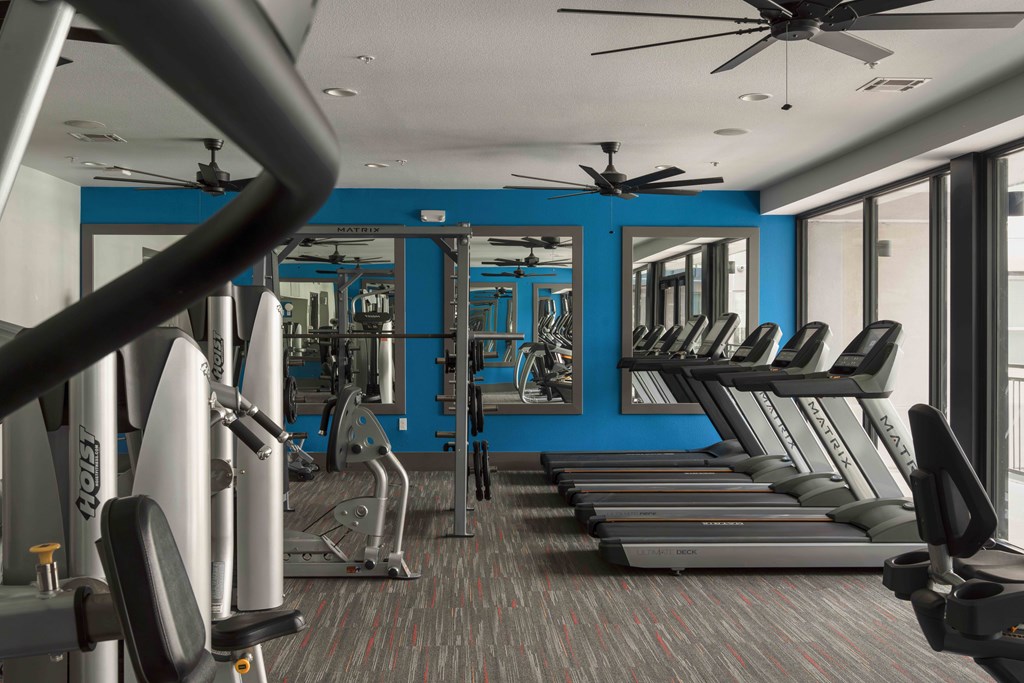 A gym with treadmills, weights, and a fan at Regatta Sloans Lake Apartments, Denver, CO, 80204