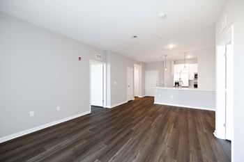 A room with wooden flooring and white walls. at Harbor Pointe, Bayonne