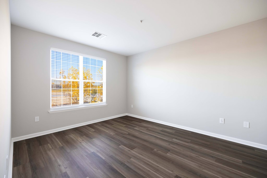 A room with a window showing trees outside. A room with a window showing trees outside. at Harbor Pointe, Bayonne, NJ, 07002