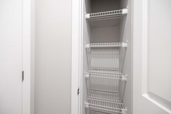 Empty white shelves in a white pantry. at Harbor Pointe, Bayonne, NJ, 07002