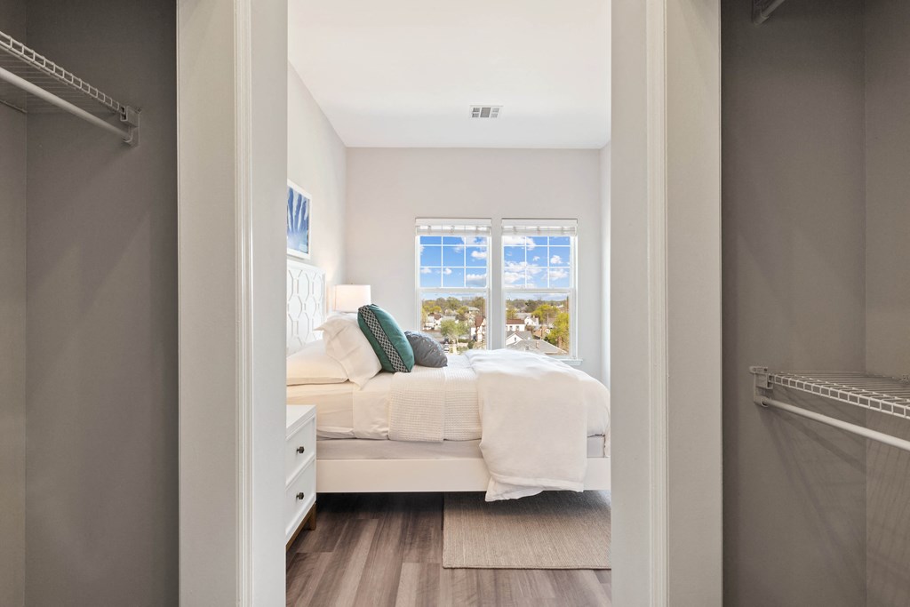 a bedroom with a bed and a window at Metro 303, Hempstead, 11550