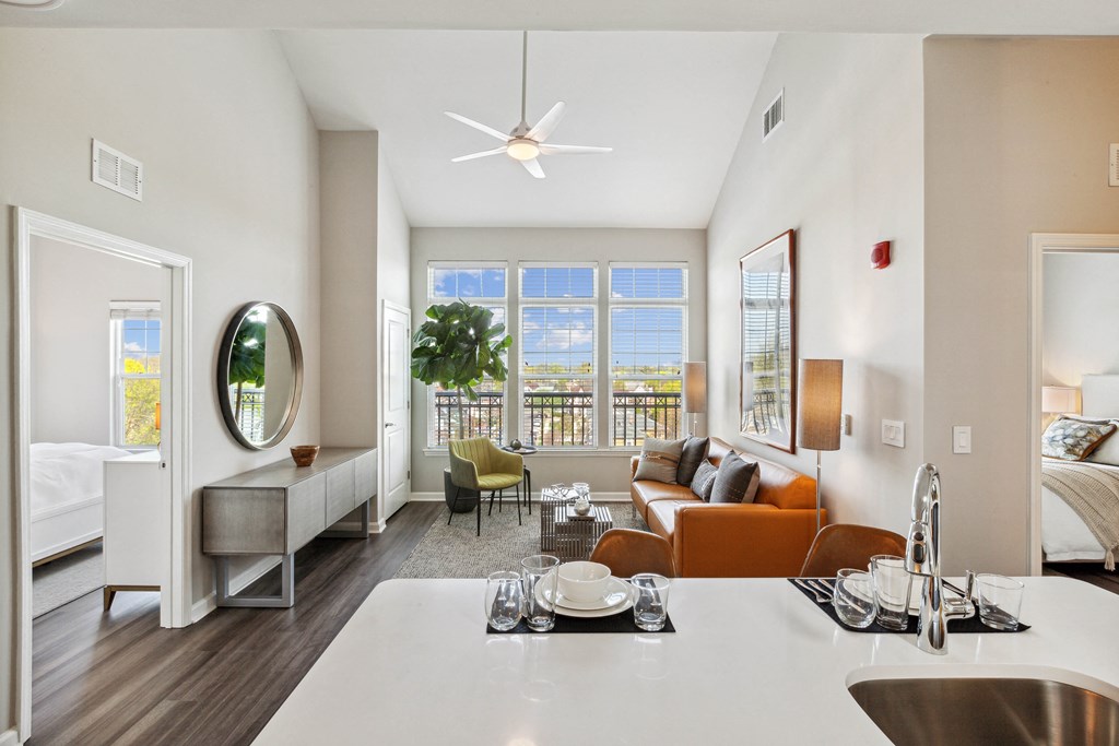 a living room with white walls and a large window with a view of a body of water at Metro 303, Hempstead