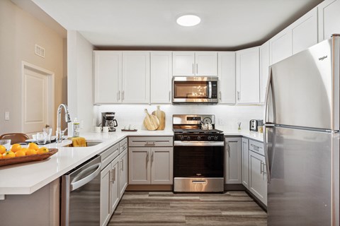 a kitchen with stainless steel appliances and white cabinets